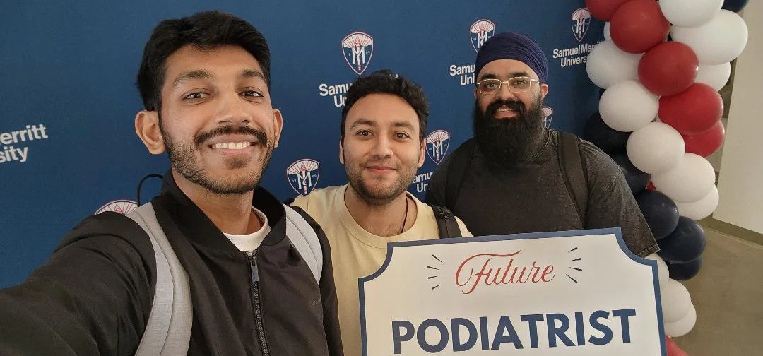 Classmates sharing a Future Podiatrist sign at a university event